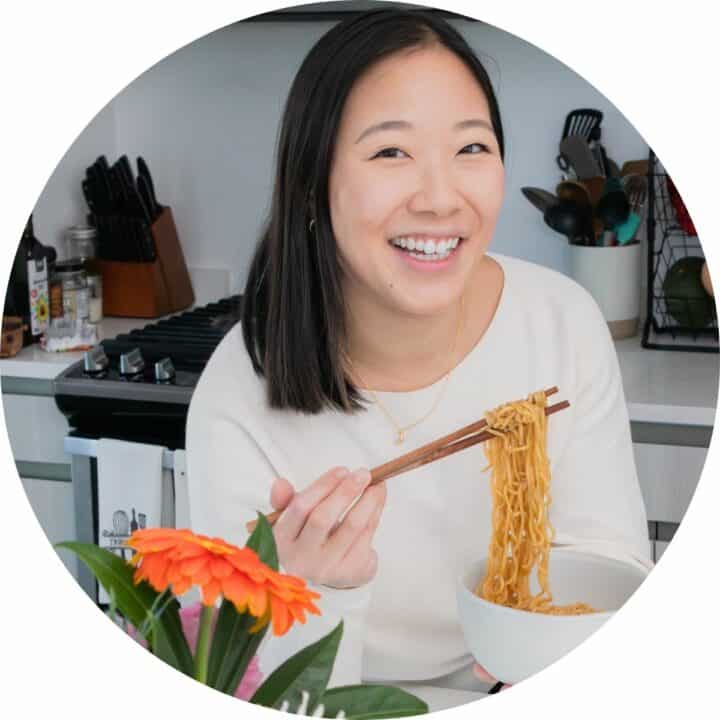 profile head shot of me holding noodles.