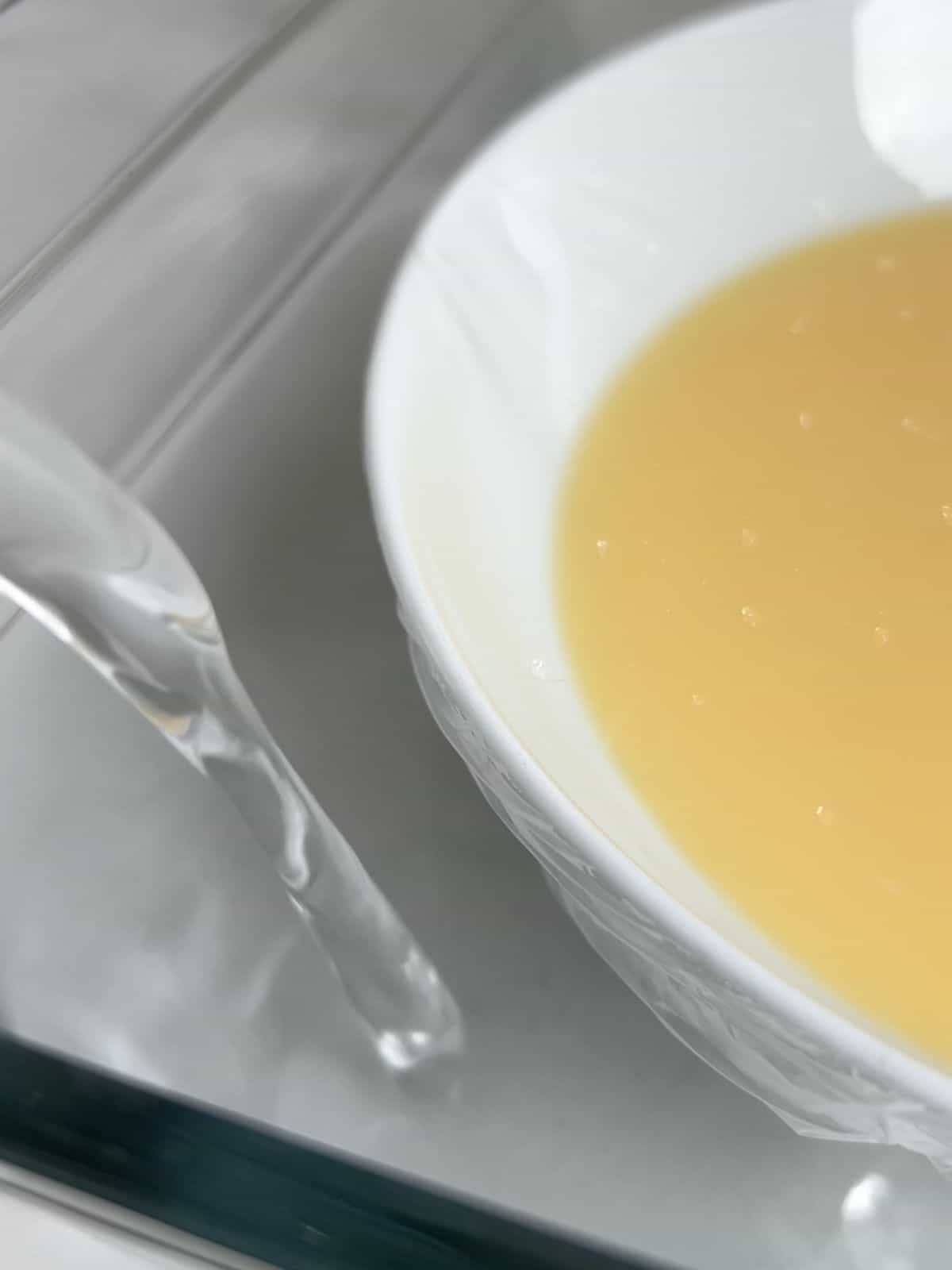 Preparing a water bath in a baking dish for the flan.