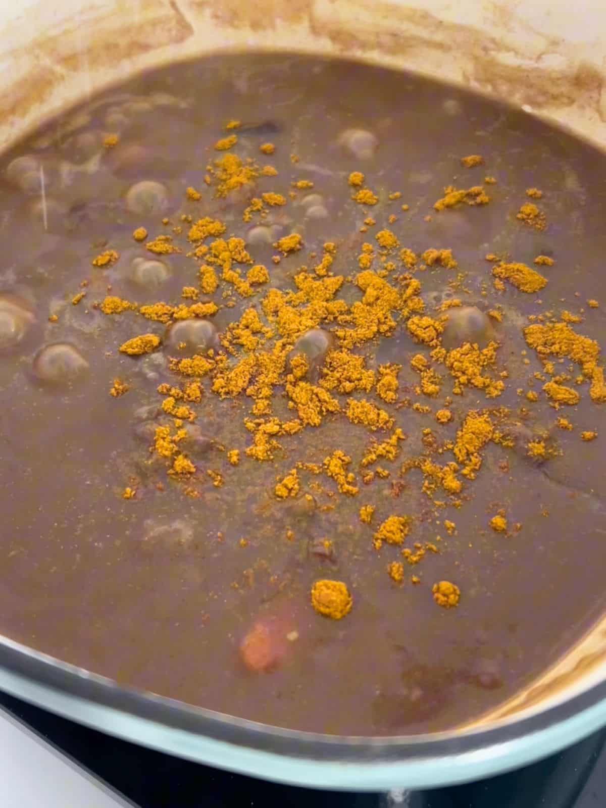 Adding Japanese curry powder to the Dutch oven.