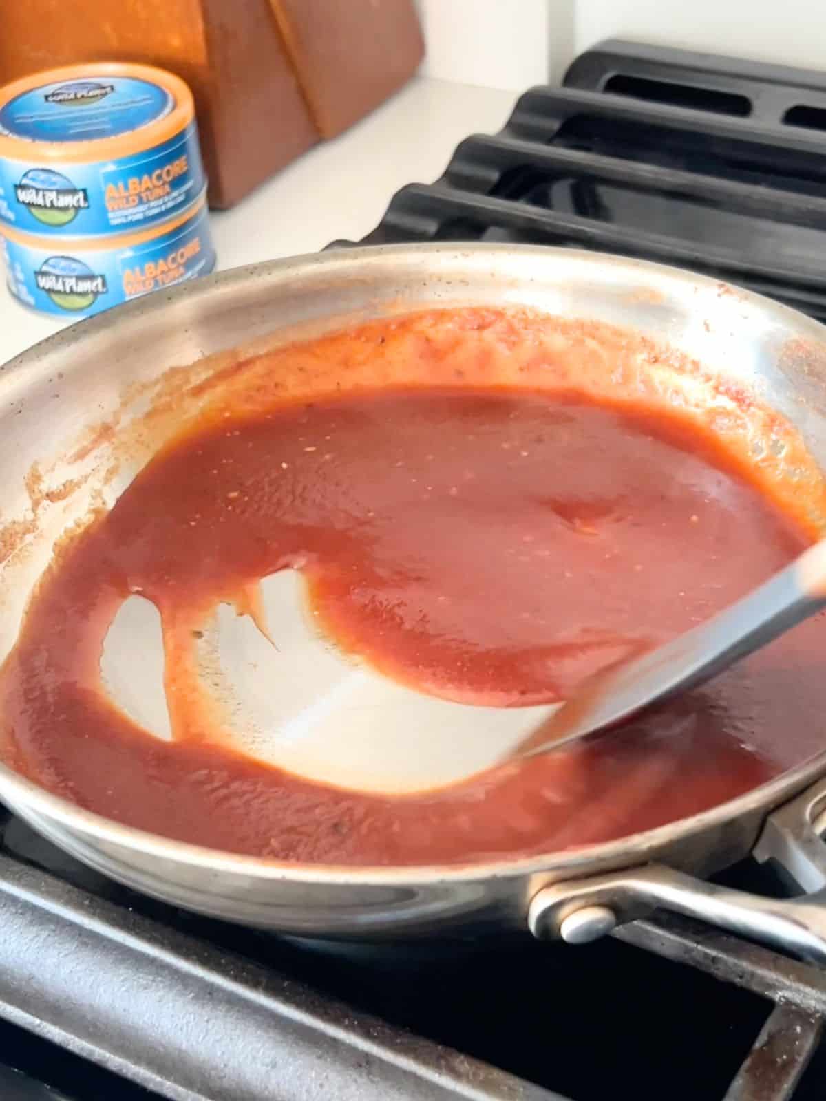 Thick homemade BBQ sauce in a skillet.