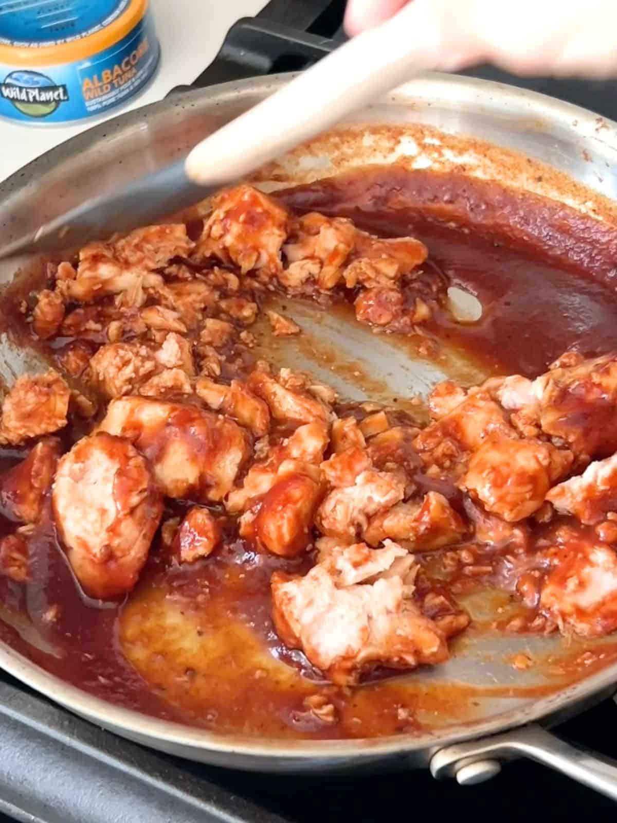 Tuna added to the homemade barbecue sauce in a skillet.