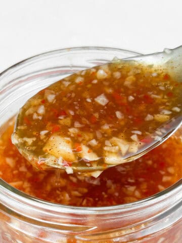 Close up shot of the sweet chili sauce on a spoon.