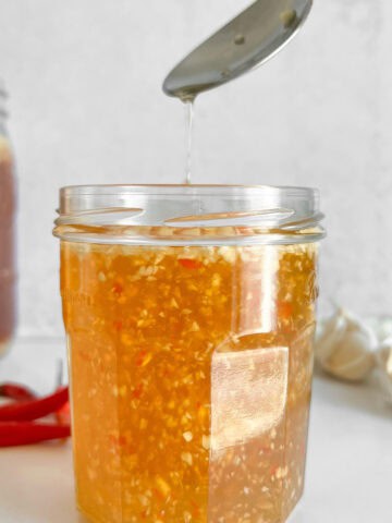 Side profile of Vietnamese dipping sauce nuoc cham in a jar.