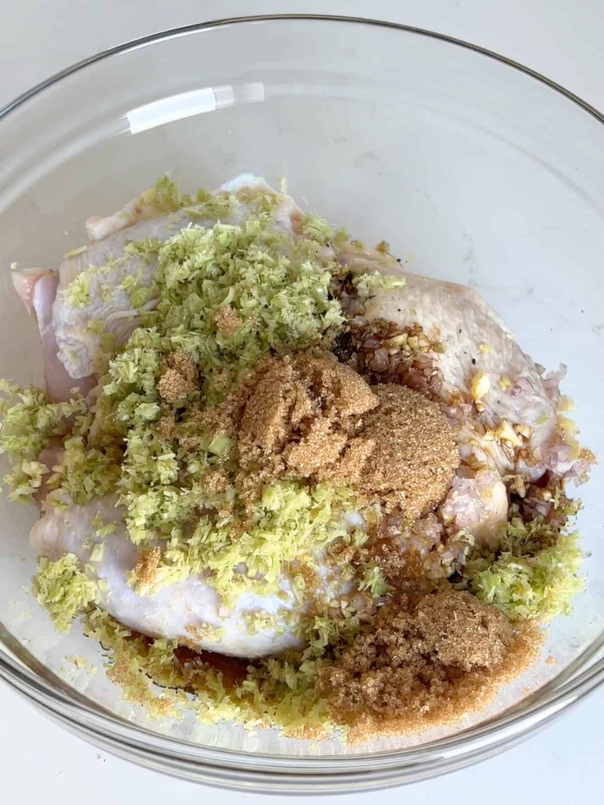Marinating the chicken thighs in a mixing bowl.