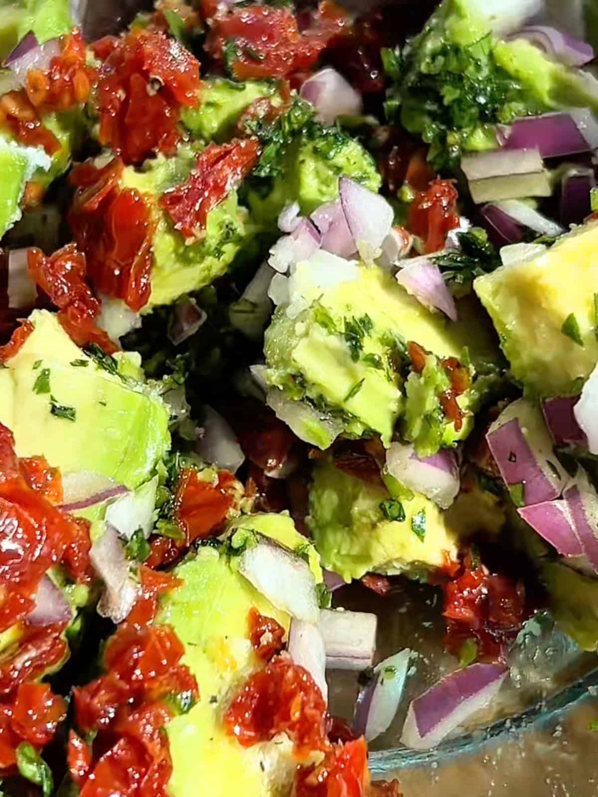 Mixing the avocado egg roll filling in a bowl.