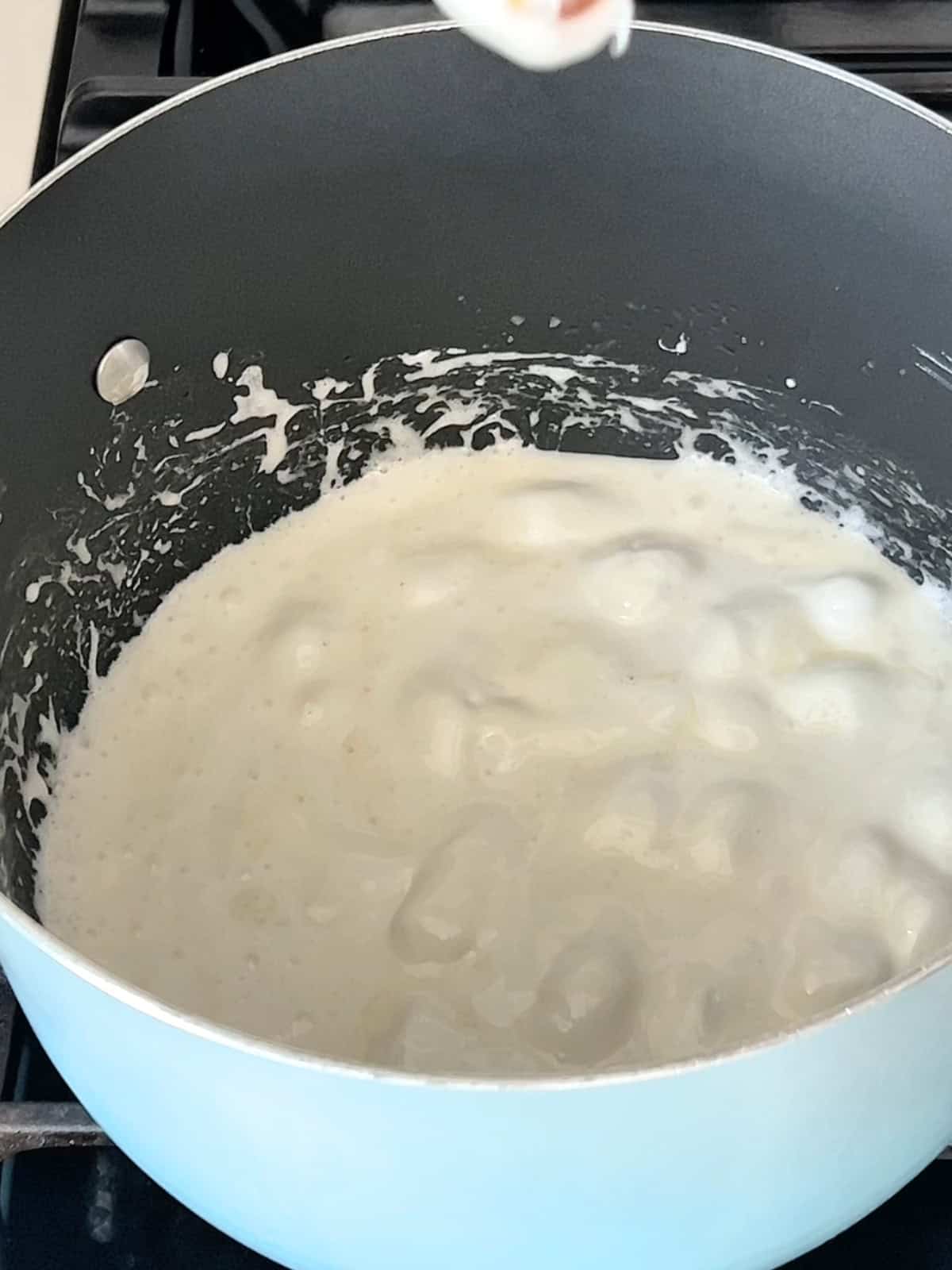Melting marshmallows in a large pot.