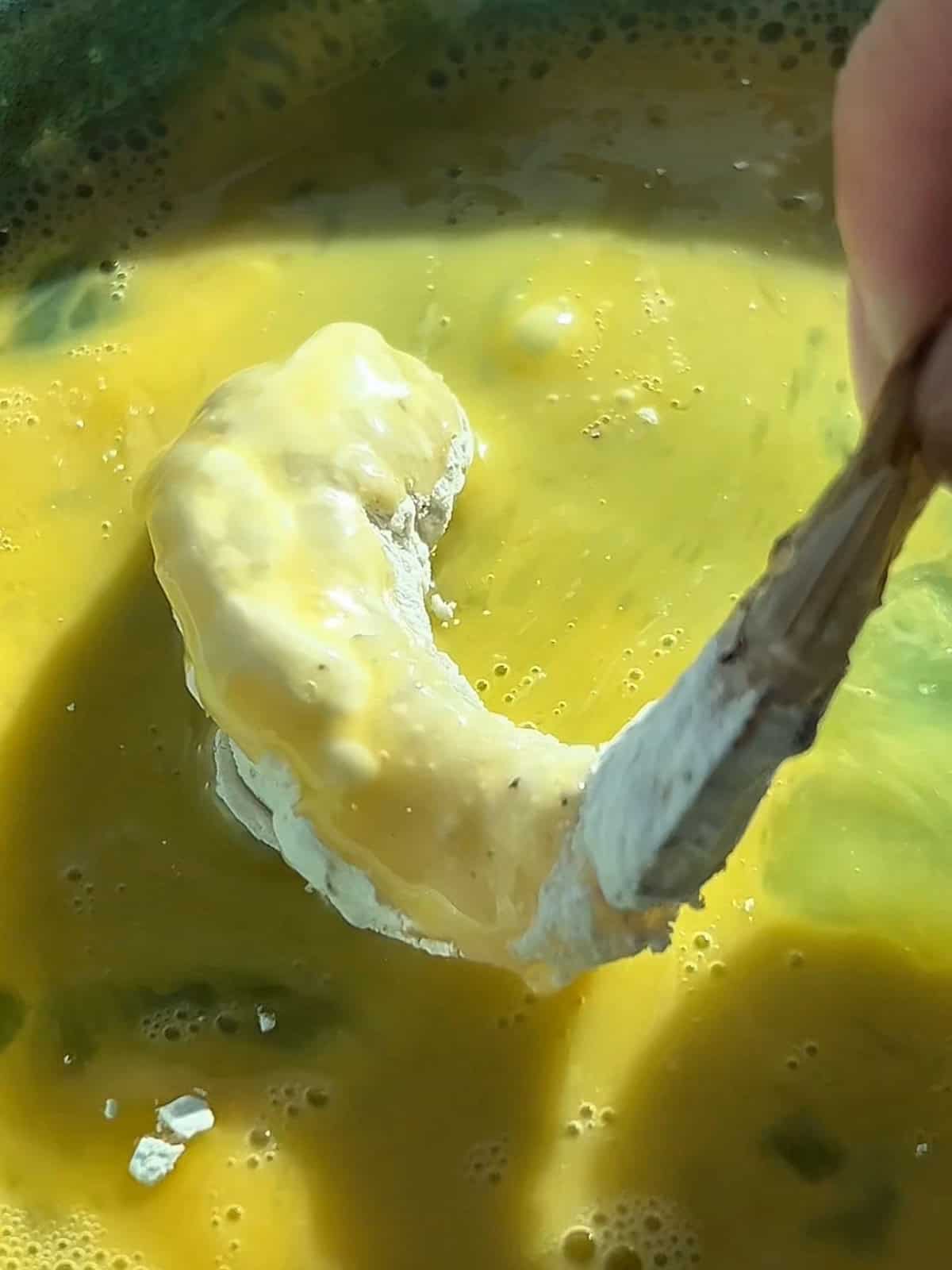Shrimp covered in flour and dunked in egg wash.