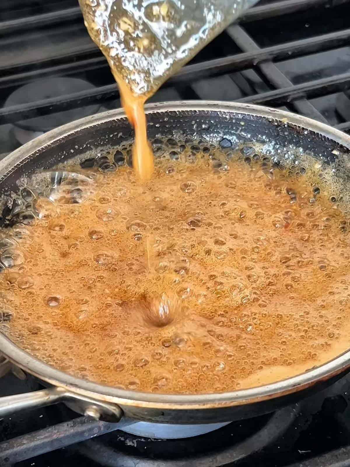 Fish sauce glaze bubbling to a boil on the stove.