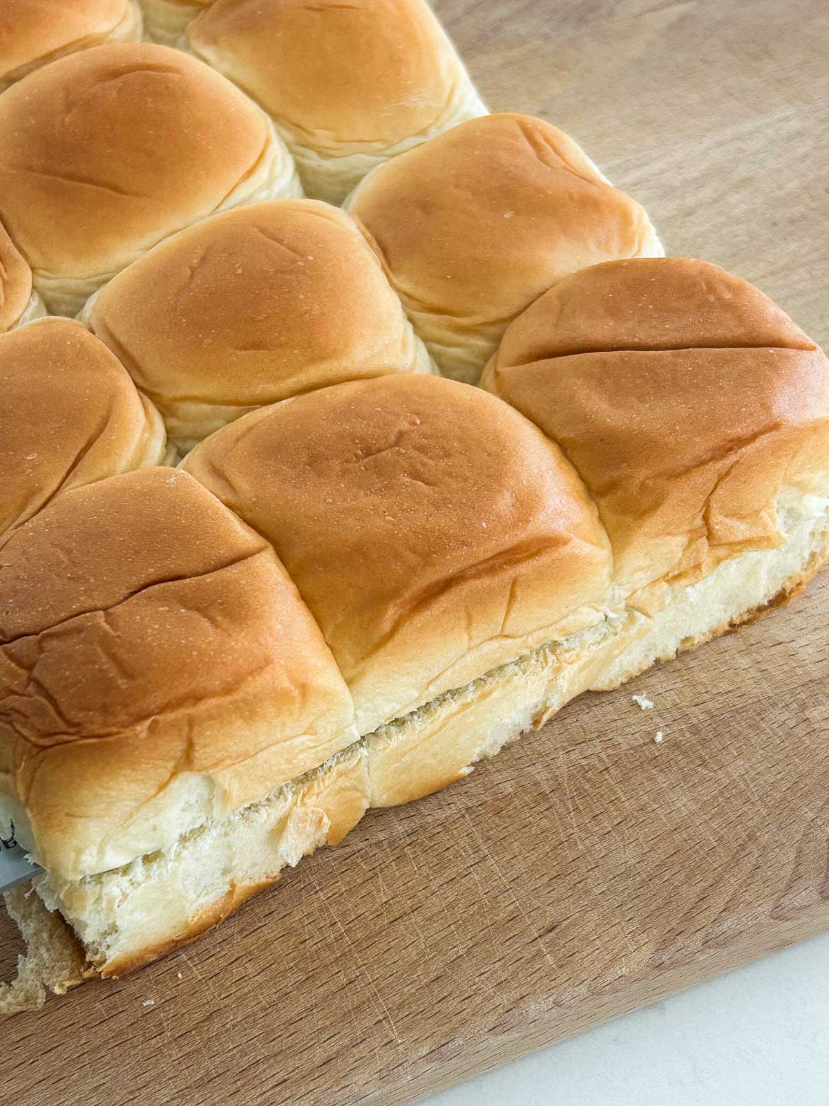 Side view of King's Hawaiian rolls sliced horizontally.