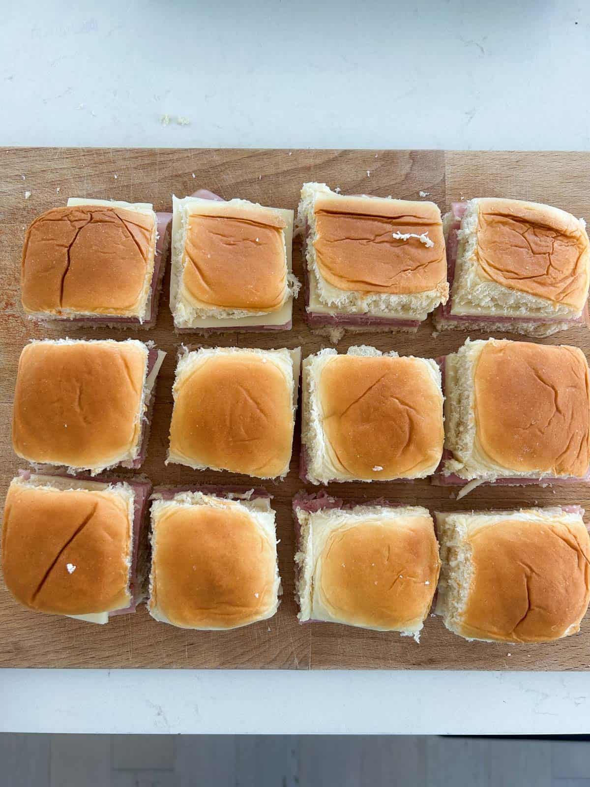 King's Hawaiian rolls cut into sliders on a cutting board.
