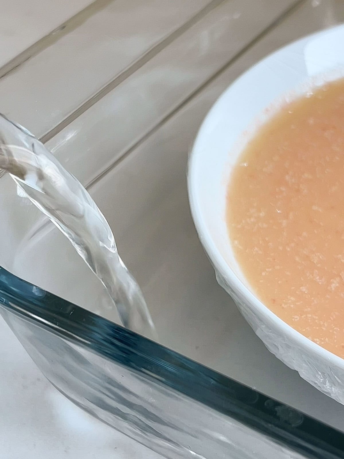 Water poured into a baking dish for a water bath.