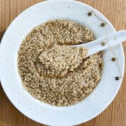 Overview of a bowl of pho pastina in a bowl plate but more square.