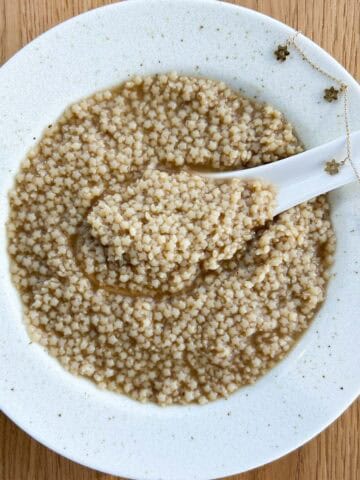 Overview of a bowl of pho pastina in a bowl plate but more square.