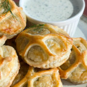 Close up of cooked salmon wellington pastry bite but in a 1x1 dimension.