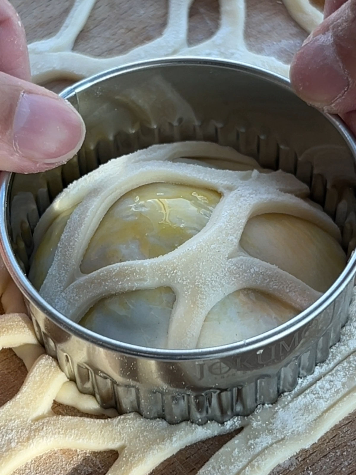 Fluted pastry cutter, cutting through puff pastry lattice on the salmon wellington bite.