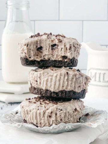 Close up shot of no bake mini oreo cheesecakes on top of each other.