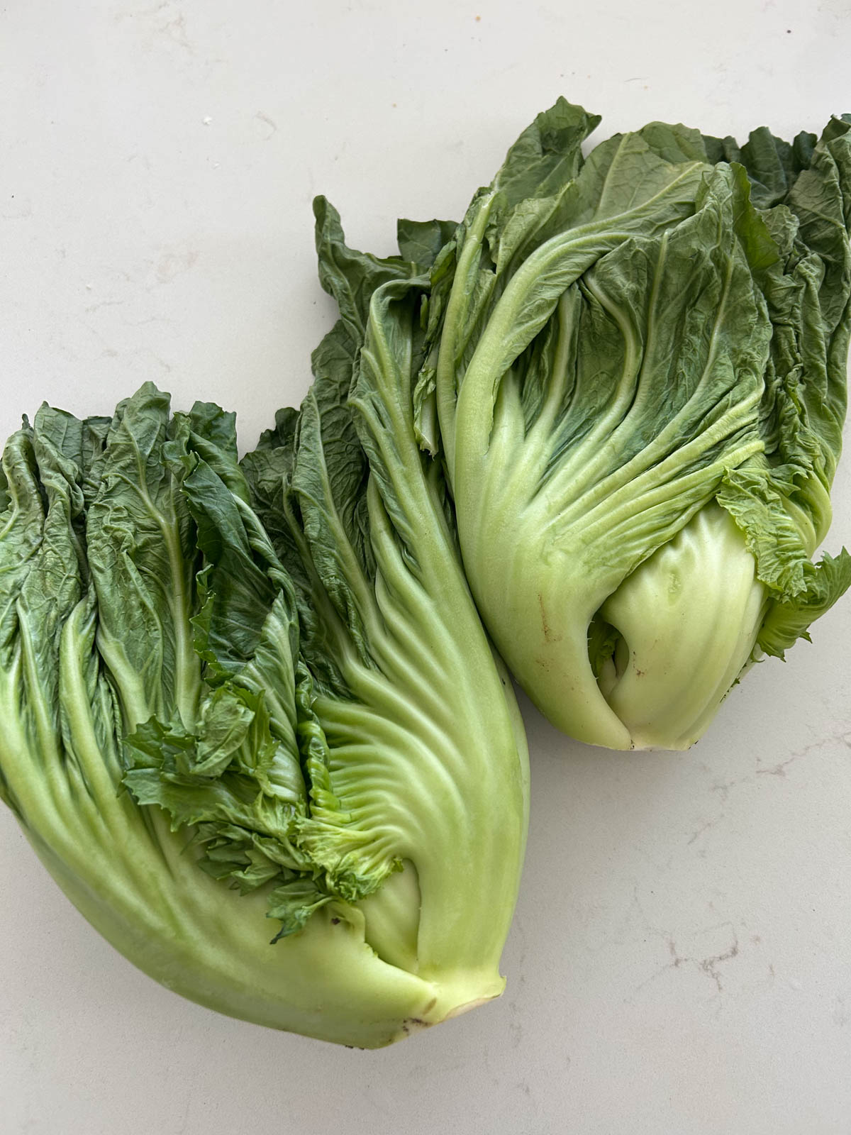Fresh whole mustard greens on table.