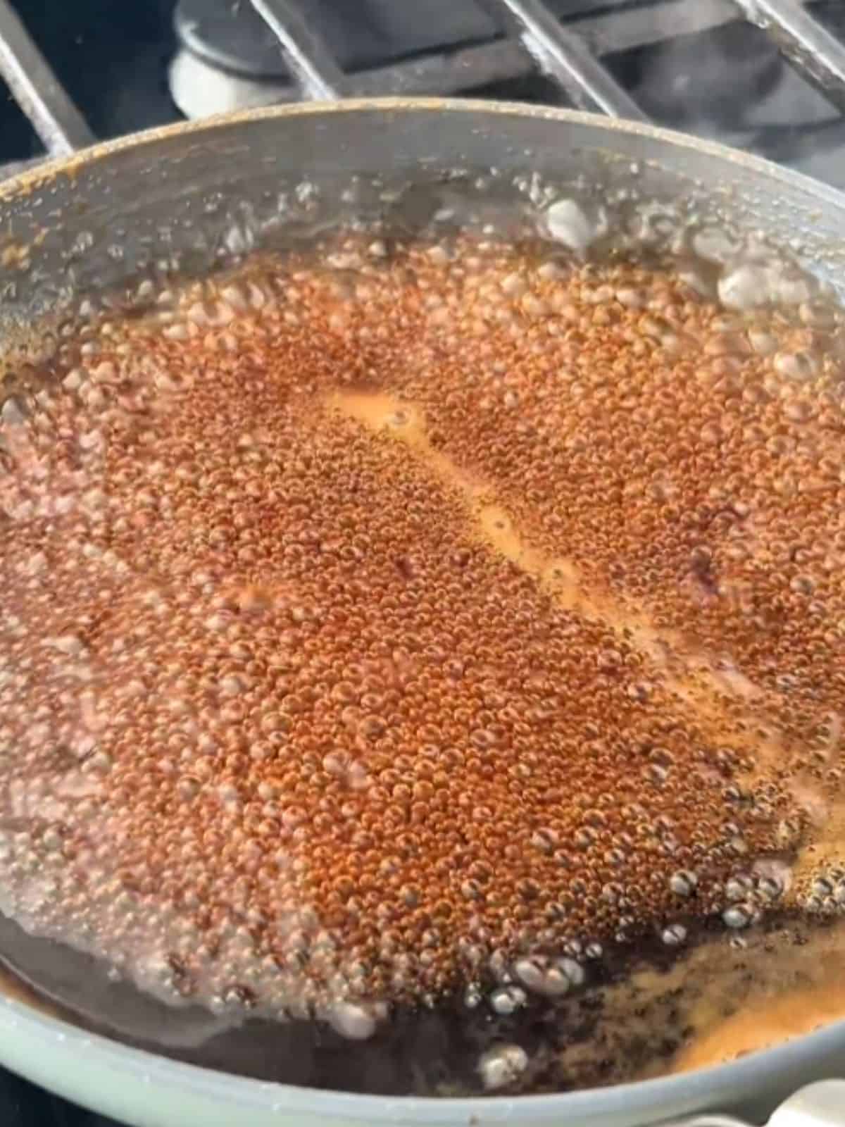 Soy sauce, brown sugar, mirin, and cornstarch slurry simmering in a pan until thickened.