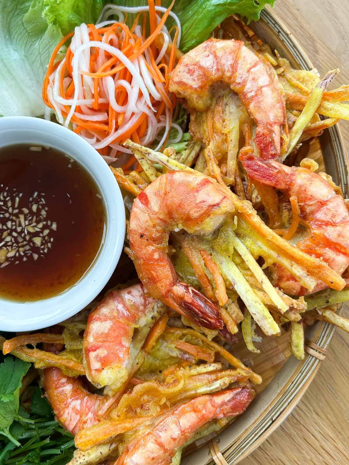 Banh tom chien with fish sauce and pickled veggies.
