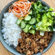 Ground chicken rice plate with veggies and herbs.