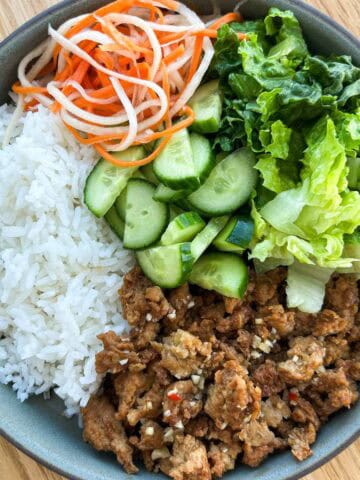 Ground chicken rice plate with veggies and herbs.